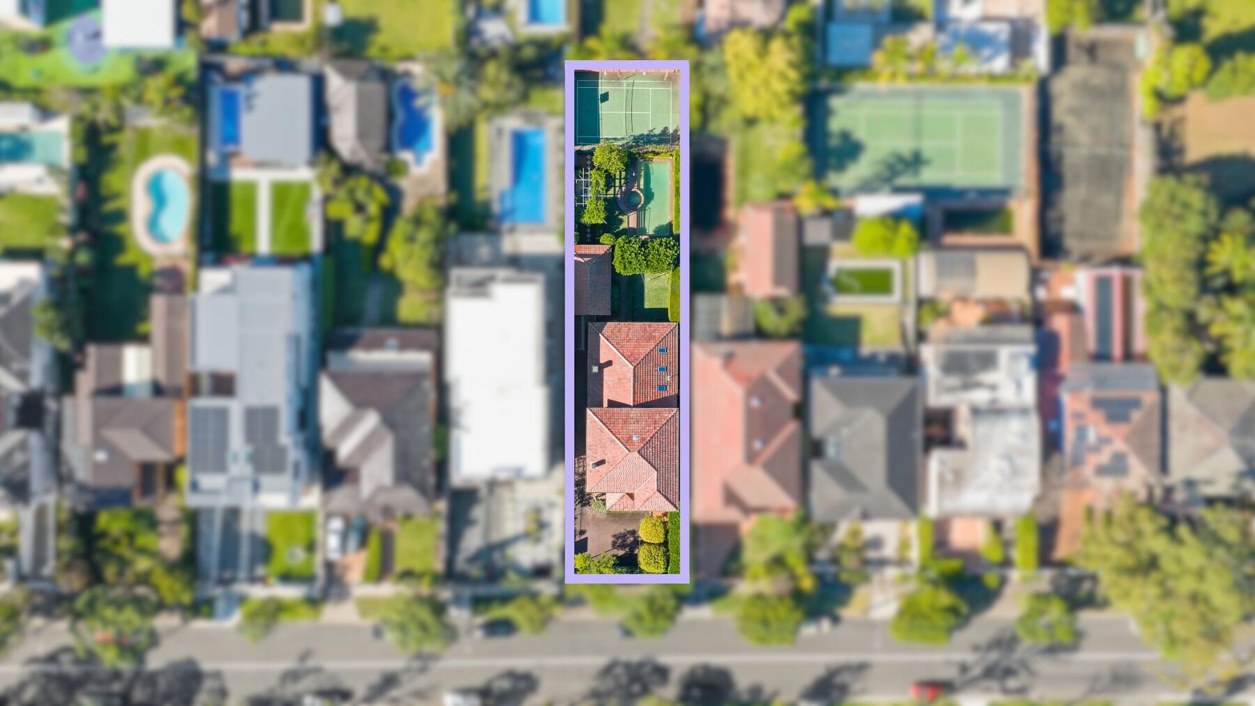 Aerial view over 32 Wallis Avenue showing the full 977 square metre block: the house, gardens, in-ground pool and private tennis court from above