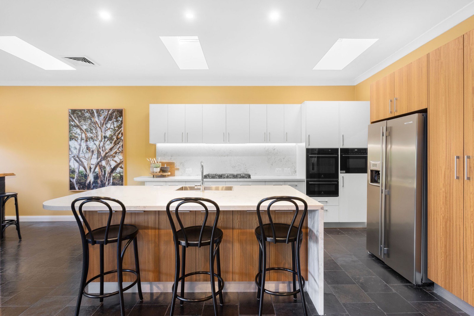 Open-plan kitchen with stone island, butler's pantry and skylights